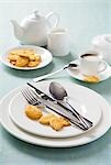 White place-setting with biscuits and coffee