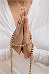 Young woman meditating with hands together