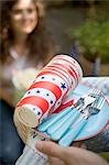 Hands holding picnic things for the 4th of July