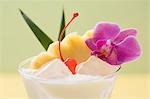 Piña Colada with pineapple, cocktail cherry and orchid