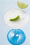 Margarita with lime wedges in a glass with a salted rim