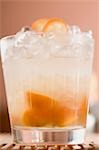Cocktail with kumquats and ice cubes