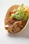 Folded tortilla filled with chicken, guacamole and cheese