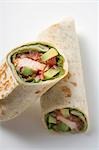 Two wraps filled with chicken and avocado