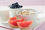 Muesli ingredients: cereal, yoghurt, blueberries, grapefruit