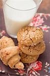 Nut croissants and amaretti, glass of milk