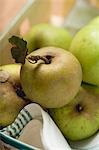 Several organic apples on tea towel