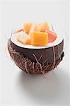 Exotic fruit salad in hollowed-out coconut