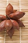 Several salak fruits on straw mat