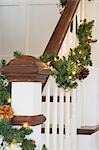 Artistic fir garland on banister rail