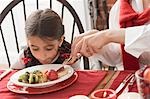 Woman and child eating Christmas dinner (USA)