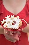 Woman holding dish of Christmas biscuits