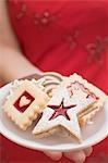 Woman holding assorted Christmas biscuits