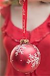 Woman holding red Christmas bauble