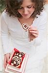 Woman taking pinwheel biscuit out of box