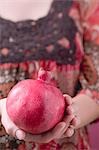 Woman holding pomegranate