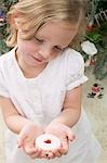 Small girl holding a jam biscuit