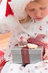 Small girl holding Christmas gifts