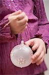 Child holding Christmas bauble