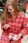 Woman holding candy cane and Christmas parcel