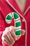 Hand holding candy cane biscuit