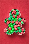 Red and green chocolate beans in biscuit cutter