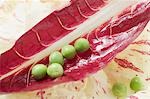 Several peas on radicchio