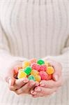 Hands holding coloured sugar-coated jelly sweets