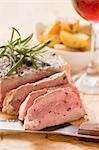 Fillet steak with rosemary, roast potatoes, glass of wine