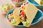 Vegetable tacos, dips in background (Mexico)