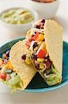 Vegetable tacos, dips in background (Mexico)