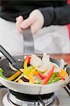 Sautéing vegetables in frying pan