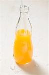 Orange juice in bottle with straw