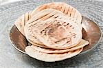 Grilled flatbread on metal plate