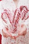 Woman holding glass of candy canes