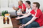 Drei Fußball-Fans mit Knabbereien und Bier vor dem Fernseher