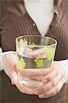 Woman holding glass of water