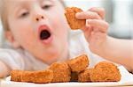 Little girl eating chicken nuggets