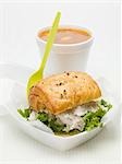 Chicken salad sandwich in polystyrene container, tomato soup