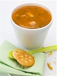 Tomato & vegetable soup in polystyrene cup, crackers