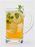 Iced tea with lemon slices and fresh mint in glass jug