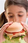 Little girl eating cheeseburger