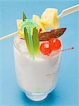 Piña Colada with pineapple skewer and cocktail cherries