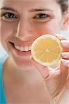 Young woman holding lemon