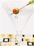 Martini with olive on cocktail stick
