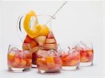 Fruity red wine punch in glass jug and glasses