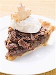 Piece of pecan pie with cream