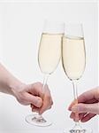 Hands clinking glasses of sparkling wine