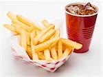 A portion of chips with cola in fast food containers