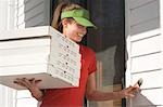 Pizza delivery girl ringing doorbell